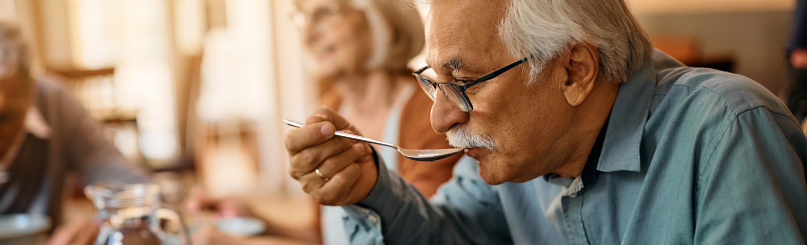 Older adult eating soup